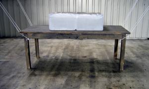 Carla Guagliardi Opera, 2004 Installation Table of wood (2,20m x 1,00m), elastic ropes and a block of ice with 150 kg.  Variable dimension